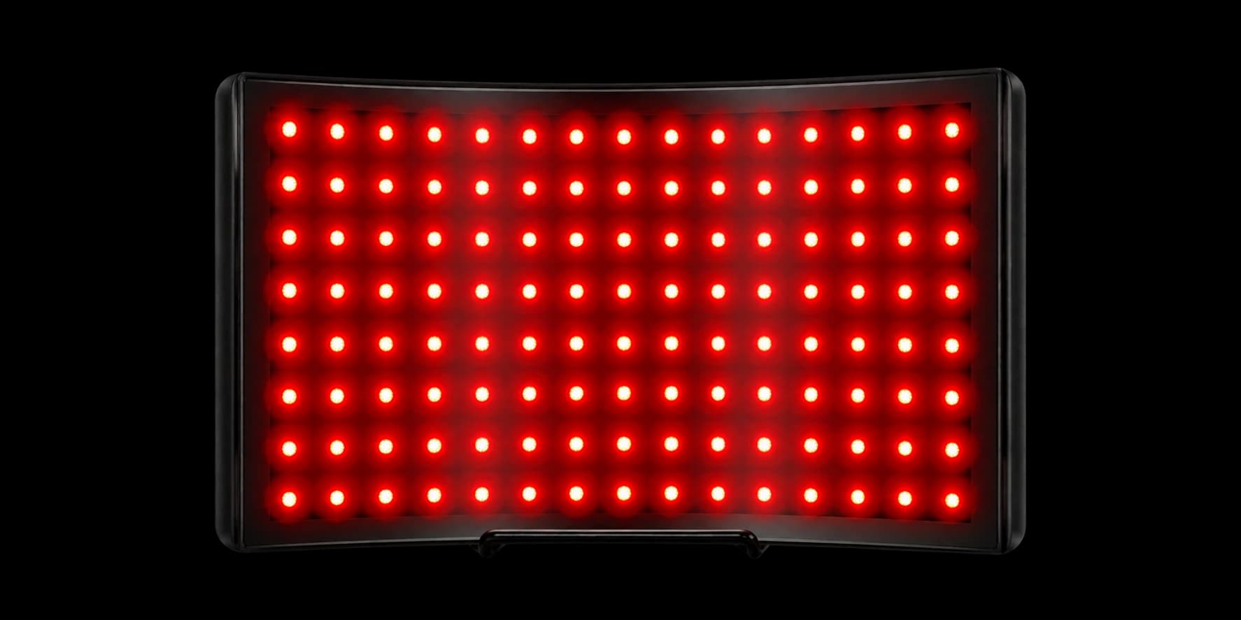 Black curved desktop red-light panel with an illuminated LED array and holder stand